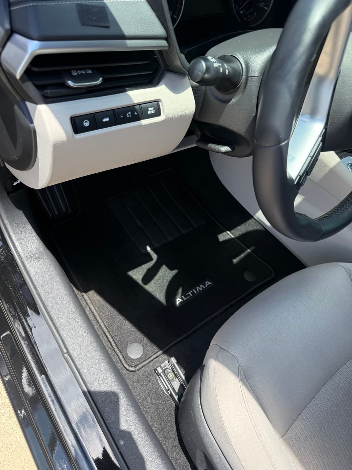 Clean Nissan Altima driver floor mat and carpet after Interior Detail Level 2